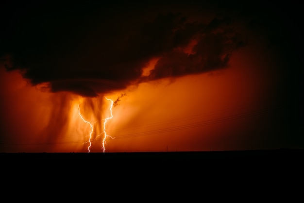 Lightning strike on the dark cloudy sky. 