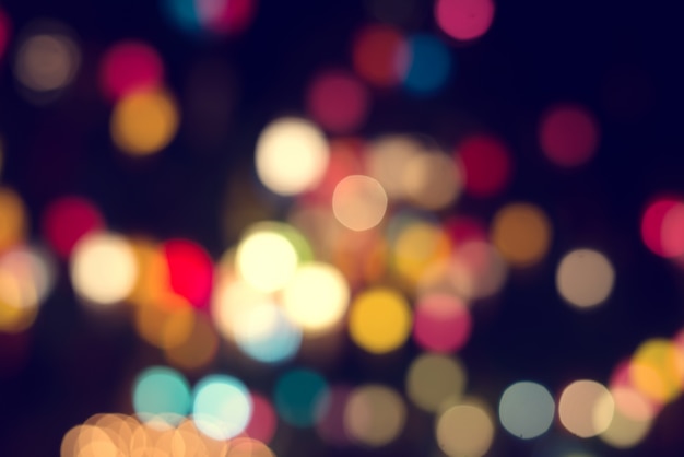 Lights blurred bokeh background from christmas night party for your design, vintage or retro color tone