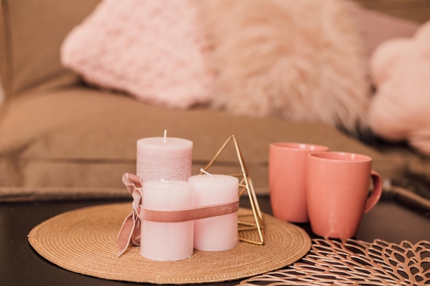 Lights and cups stand on the coffee table near the sofa