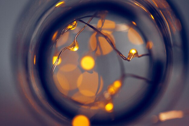 Lights garland in a glass bottle on a dark background