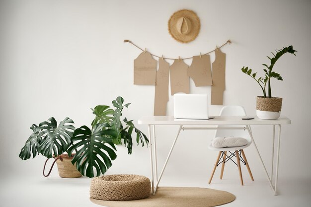 A ligth designer office interior with a green flowerpot Stylish workplace