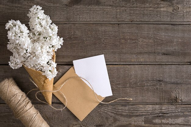 Lilac blossom on rustic wooden background with empty space for greeting message scissors thread reel...