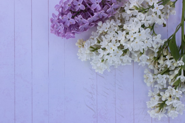 lilac bouquet on wooden table with copyspace, top view