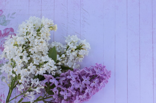 lilac bouquet on wooden table with copyspace, top view