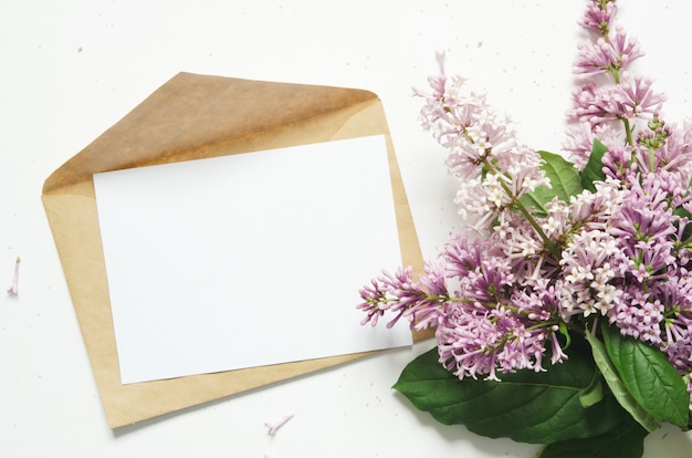 Lilac flowers and envelope. Spring flowers. Top view, flat lay. Copy space. 