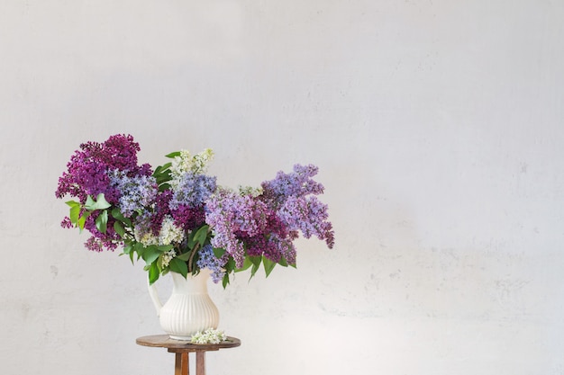 Lilac in jug on white backgound