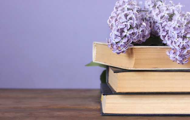 Lilac and a stack of books on the table. Copy space. Empty space for Your text.