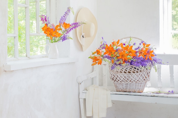 Lilly and lupine flowers in vintage white interior