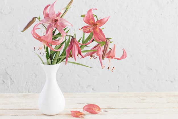 Lily in vase on background white wall