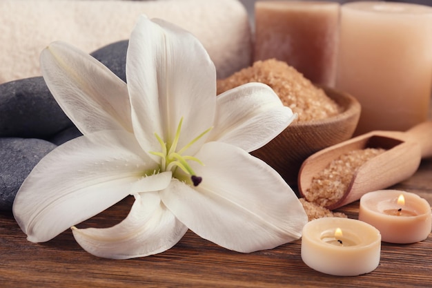 Lily with spa stones and candles closeup