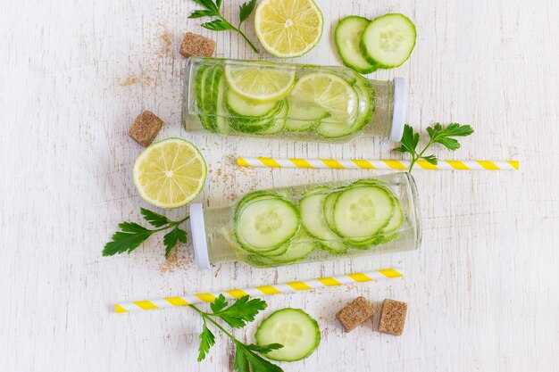 Lime, cucumber, parsley lemonade in bottles on a white backgroun