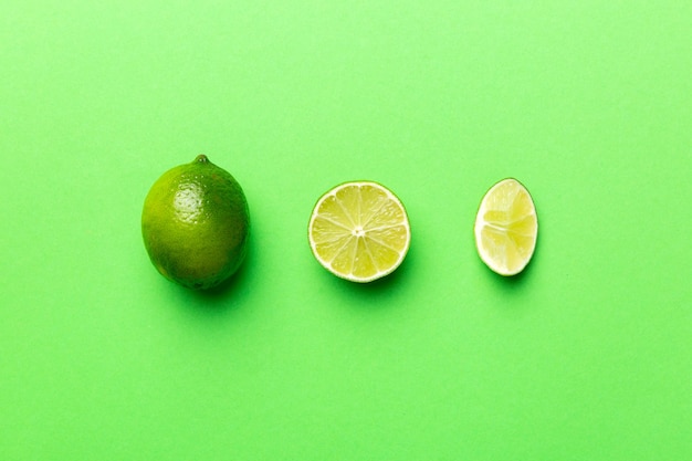 Lime fruits with green leaf and cut in half slice isolated on white background Top view Flat lay with copy space