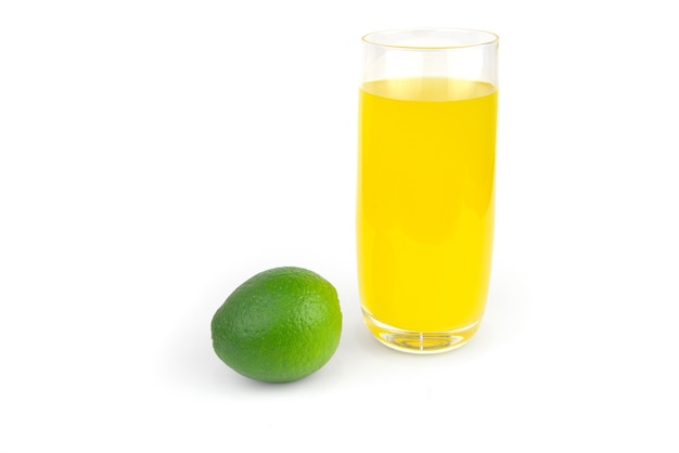 Lime and glass of juice isolated on white