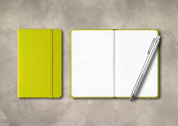 Lime green closed and open lined notebooks with a pen . mockup isolated on concrete background