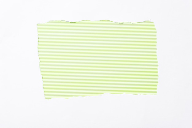 Photo lime green striped colorful background in white torn paper hole