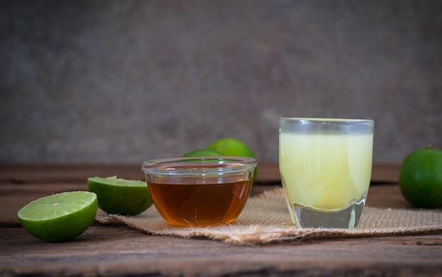 Foto limone lime con succo e miele in vetro trasparente