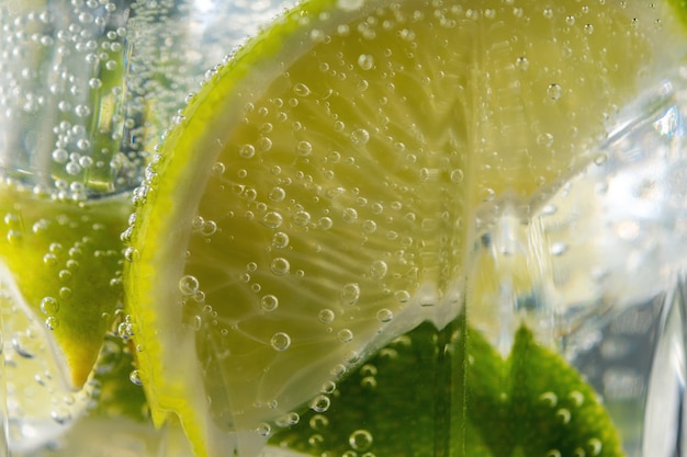 Lime slice with a drops in fizzy sparkling water