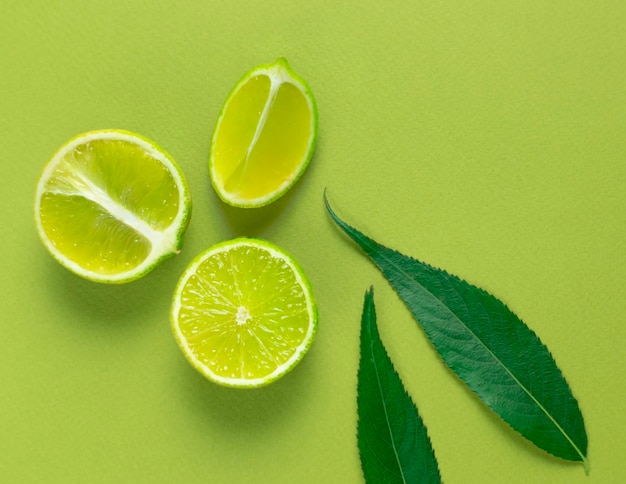 Lime slices on a green background.