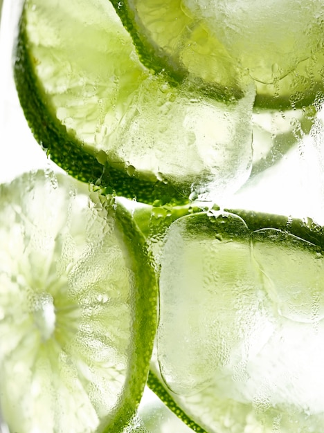 Lime slices in ice macro with condensation droplets