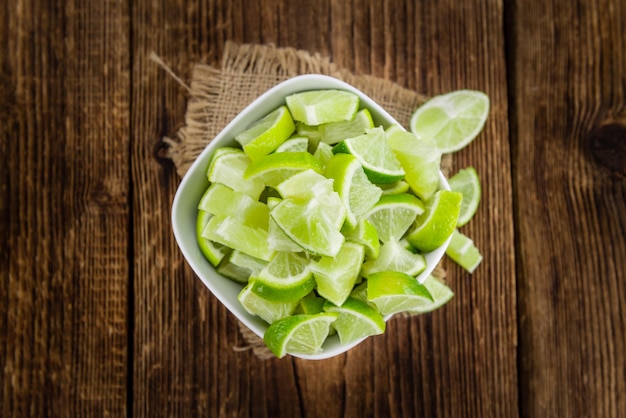 Lime Slices selective focus on vintage wooden background