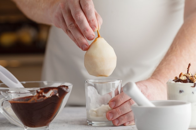 Lime and vanilla ice cream in a cup with mint and wooden spoon