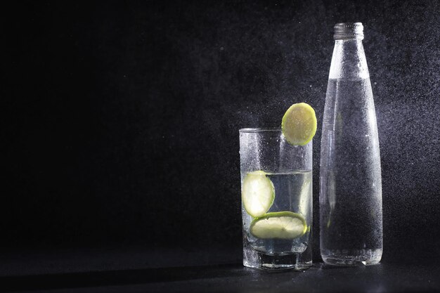 Lime water. Drinking water with fresh lime. Mineral water. Healthy, mineral-rich, refreshing water with lime.