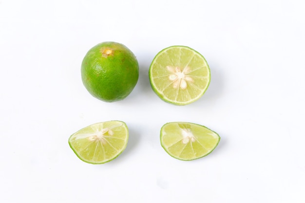 Lime with slices isolated on white background