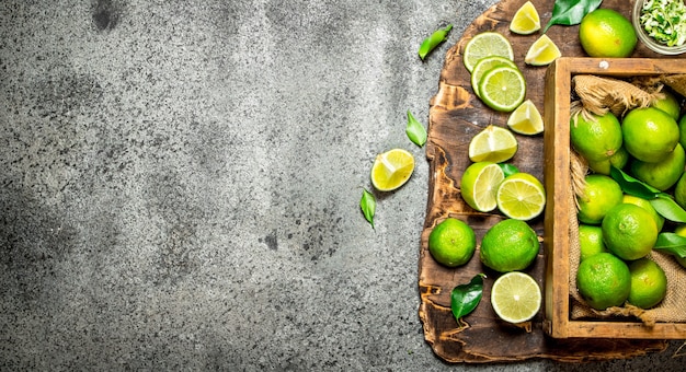 Photo limes in the old box on rustic table.