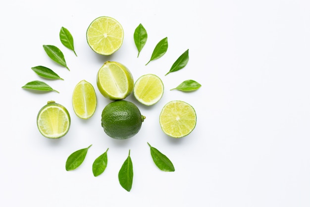 Limes with leaves isolated on white background.