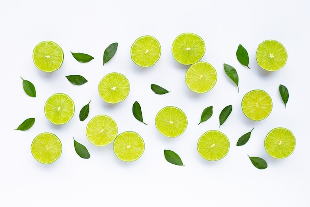 Limes with leaves isolated on white.