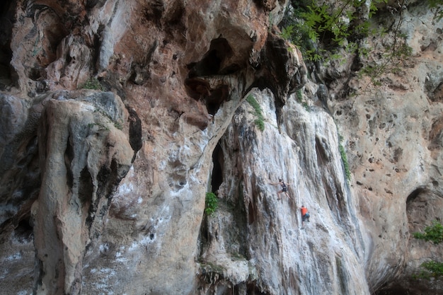 Limestone wall with tourist climbing in Krabi province at Thailand.