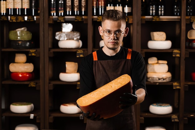 Limited gouda cheese in hands of cheese sommelier Snack tasty piece of cheese for appetizer