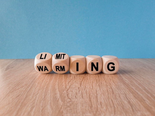 Limiting global warming symbol Concept words Limiting and Warming on wooden cubes