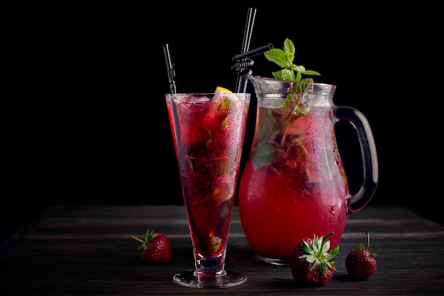 Limonade een aardbei in een glas op een donkere achtergrond