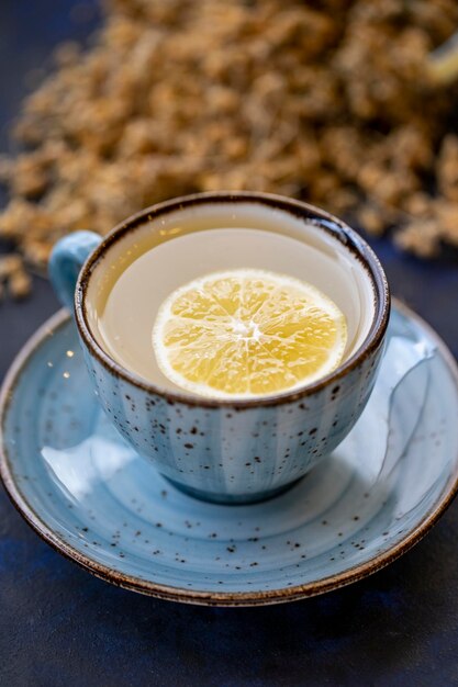 Linden tea in a cup on a black and blue background