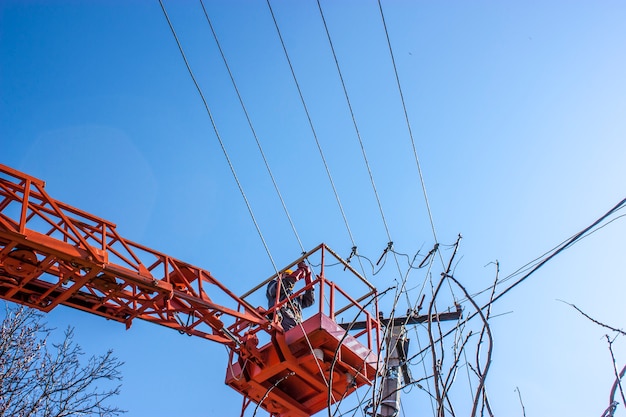 lineman duty working fix power line on electrical cable with aerial work platforms