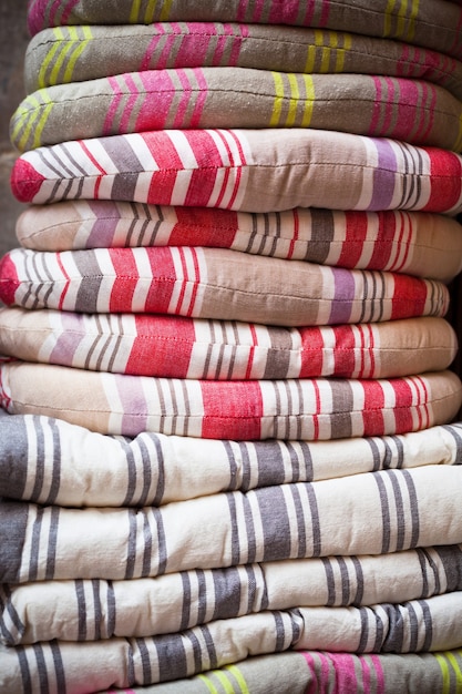 Linen chair pillows pile. Vertical outdoor shot.