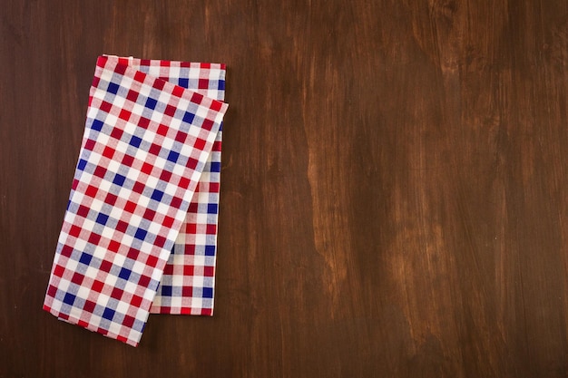 Linen dinner napkins on a wood background.