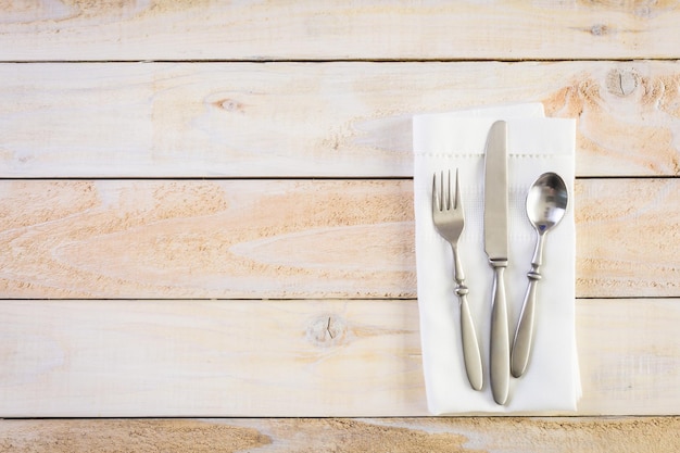 Linen dinner napkins on a wood background.