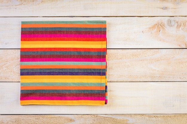 Linen dinner napkins on a wood background.