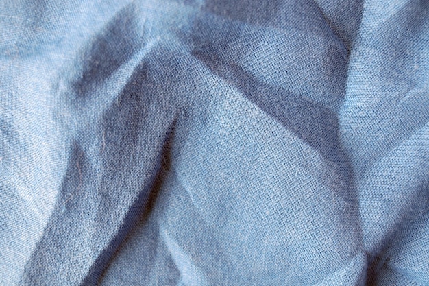 Linen fabric pastel grayblue shade of color crumpled texture of natural fabric top view