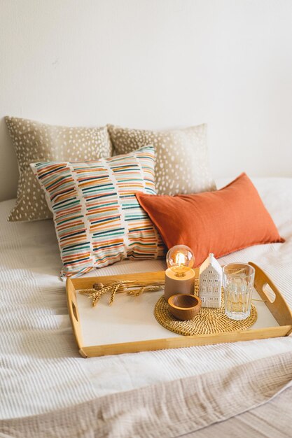 Linen pillows on a white bed with home decor Still life details in home on a bed Cozy home Sweet home