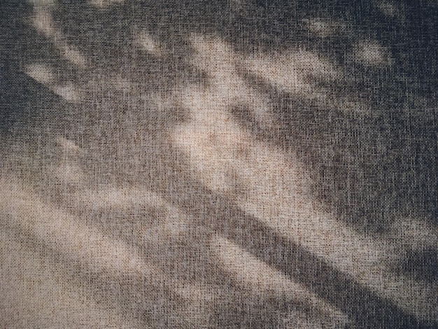 Foto trama di lino e ombre come sfondo rustico