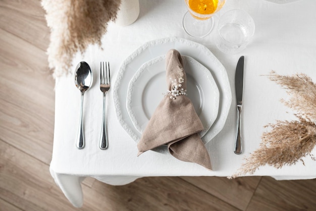 Linen white tablecloth and beige napkin