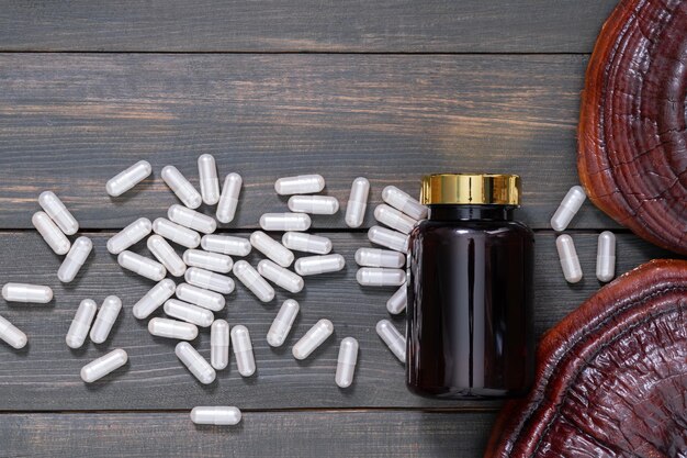 Photo ling zhi mushroom and capsule with bottle mockup