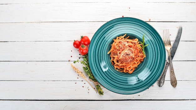 Photo linguine pasta with tomatoes on a wooden background italian cuisine top view copy space