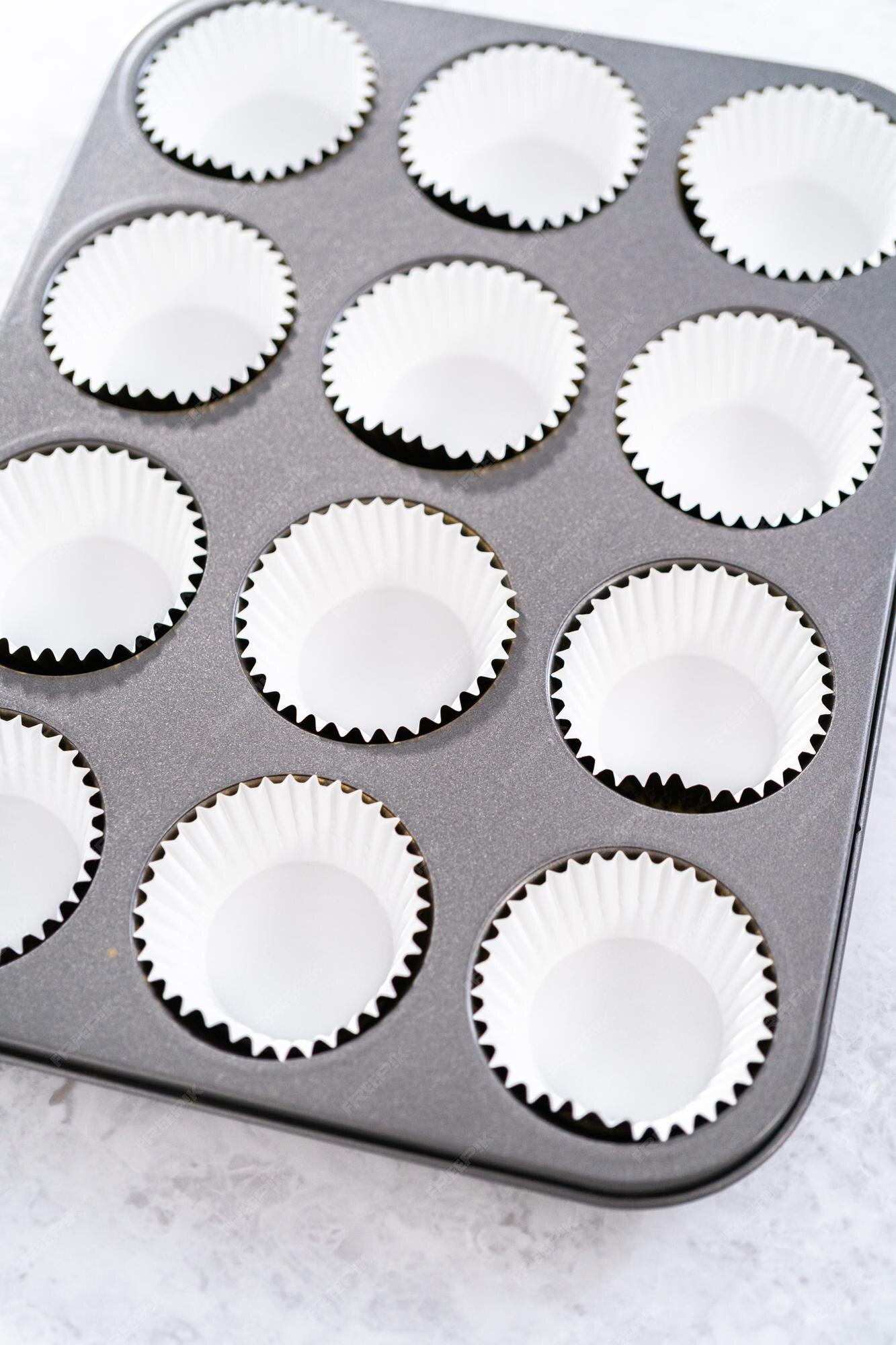 Premium Photo  Lining cupcake baking pan with foil cupcake liners