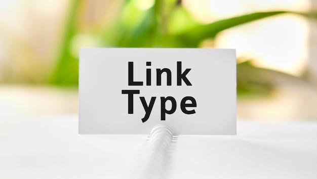 Link type text on a white notebook and green flowers