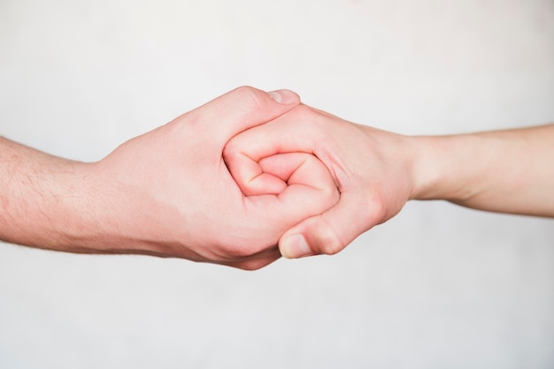 Linked hands on white background