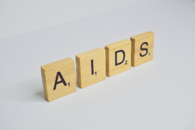 Foto linkeraanzicht van de woorden aids van scrabble-letters op een witte achtergrond